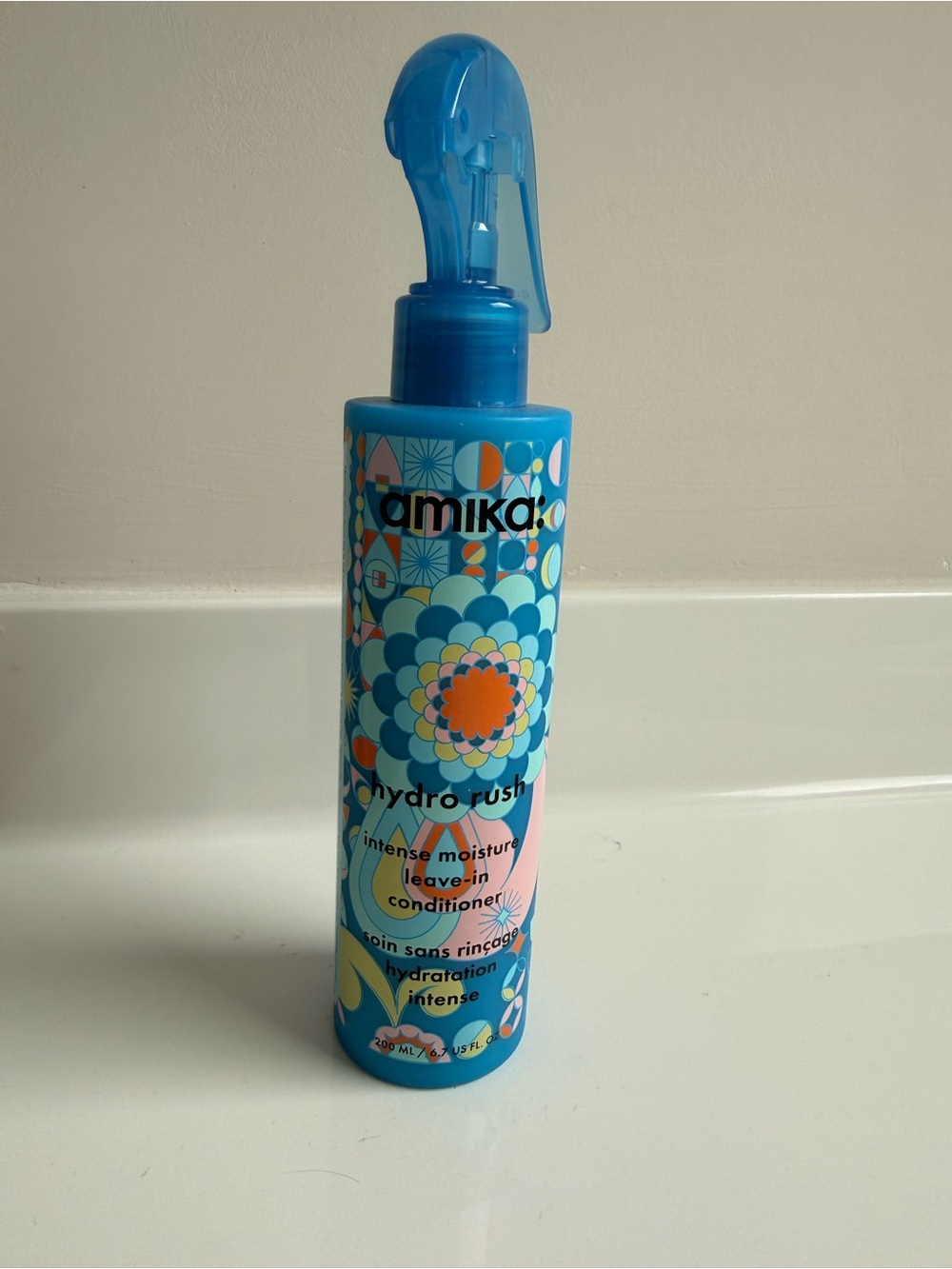 amika Hydro Rush Intense Moisture Leave-In Conditioner - Blue with Orange Accent